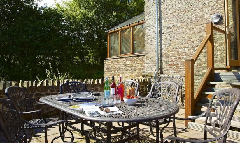 Attractive walled and paved terrace with garden table, six chairs